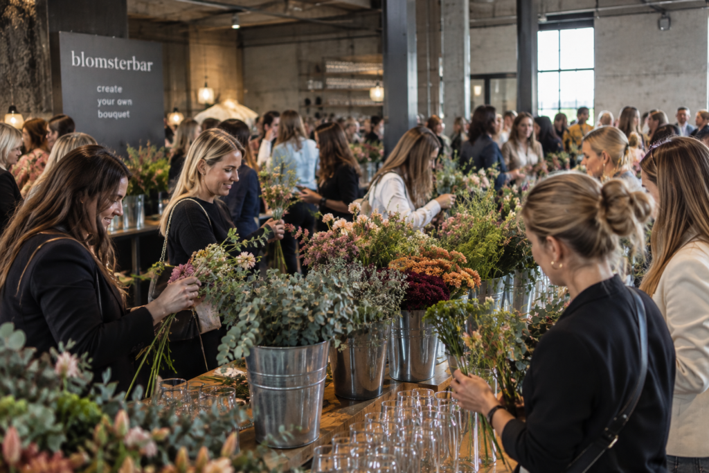 Blomsterbar til firmaevents med gæster, der binder deres egne buketter